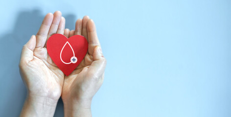 Hand holding red heart and blood drop donation, save life, world hemophilia day concept, world blood donor day, hospital, life and health insurance, world mental health day