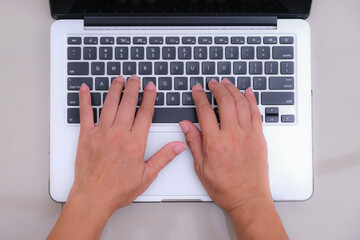 Fototapeta na wymiar Flat lay; Woman hands typing on a laptop.