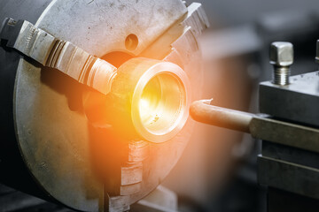 Type of metal processing lathe part. Industrial background. Solar glare or illumination..