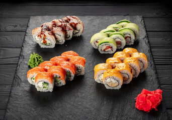 Assorted sushi nigiri and maki big set on slate. A variety of Japanese sushi with tuna, crab, salmon, eel and rolls