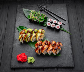 Assorted sushi nigiri and maki big set on slate. A variety of Japanese sushi with tuna, crab, salmon, eel and rolls