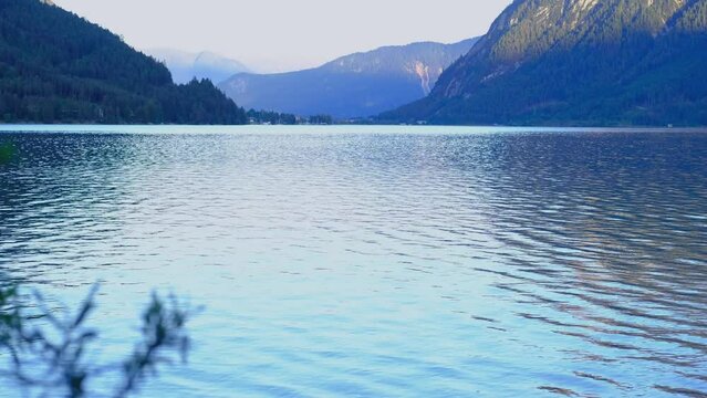 mountain landscape, lake Achensee in tyrol, green mountains rises above calm expanse of water, concept of Austrian water resources, fishing permit, vacation by reservoir, resort place tyrol