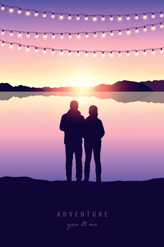 romantic couple silhouette by the lake at sunset