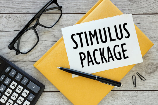 stimulus package torn page from a notebook on a yellow notepad. view from above