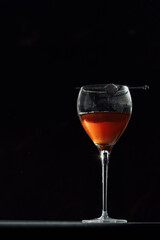 Manhattan cocktail on a table top with a dark background
