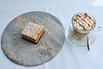 Chocolate cheesecake with cappuccino drink on a white background