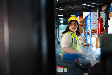 Asian fat female warehouse worker drive forklift in warehouse. Warehouse staff worker by goods shelf working in large warehouse factory © NVB Stocker