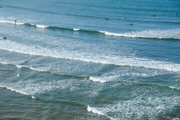 People enjoy the waves at the beach of Rabat in Morocco