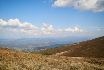 Natural landscape in the mountains in summer. Sunny rural scenery with bright blue sky. Nature protection concept.
