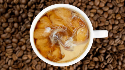 Cup of coffee with froth and roasted coffee beans  on background. Hot black coffee in white cup