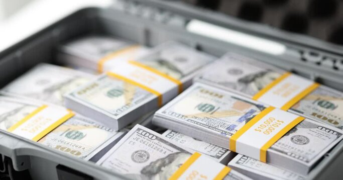 Closeup of briefcase with stacks of dollar bills. Crime and bribe business success concept