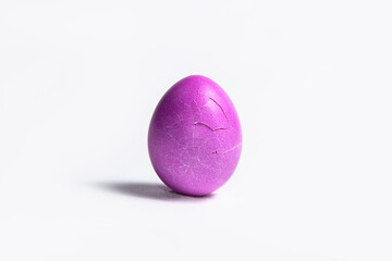 Cracked pink Easter egg isolated on a white background