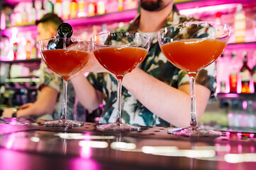 man hand bartender making cocktail in glass on the bar counter