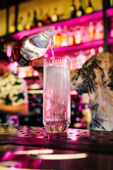 man hand bartender making cocktail in glass on the bar counter