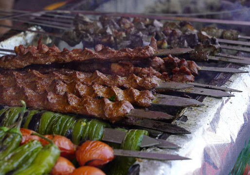 Traditional Turkish Adana Kebab or Kebap meat texture background with skewers in the turkish restaurant for dinner. Turkish cuisine food culture in Turkey.                         