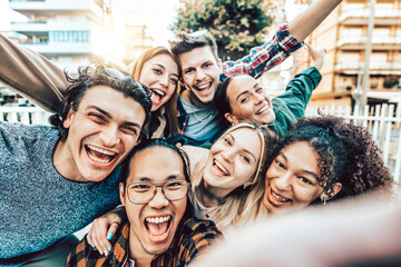 Multicultural best friends having fun taking group selfie portrait outside - Young students...