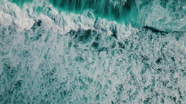 Huge waves crash on the reef. Beautiful texture of water and foam. Aerial view