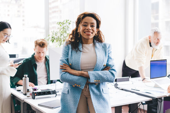 Cheerful Black Woman Smiling And Looking At Camera In Office Space