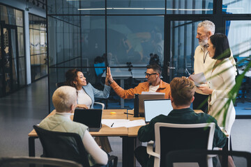 Positive businesspeople working on netbooks in office