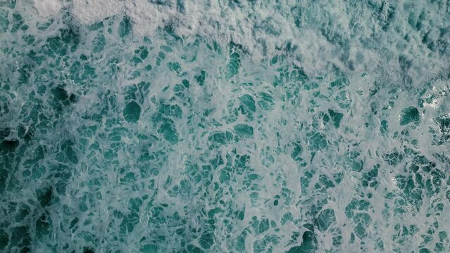 Huge waves crash on the reef. Beautiful texture of water and foam. Aerial view