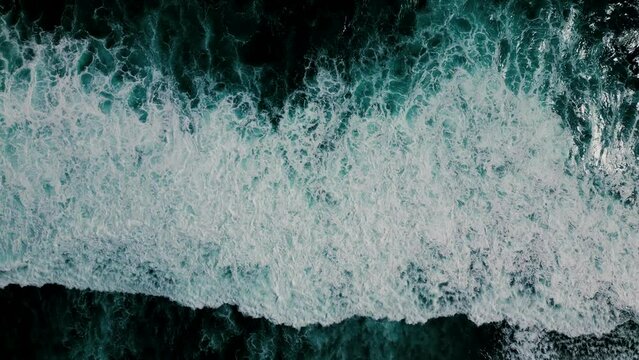 Huge waves crash on the reef. Beautiful texture of water and foam. Aerial view