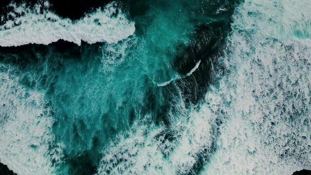 Huge waves crash on the reef. Beautiful texture of water and foam. Aerial view