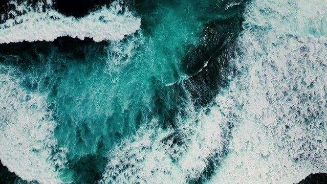 Huge waves crash on the reef. Beautiful texture of water and foam. Aerial view