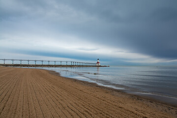 Fototapeta premium Michigan City Lighthouse and beach with storm clouds approaching. Michigan city, Indiana, USA.
