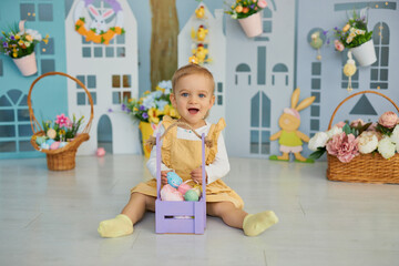 Obraz na płótnie Canvas Baby girl celebrate Easter. Funny happy kid playing on Easter egg hunt. Family home decoration, colorful Easter eggs and flowers. Home decoration and flowers