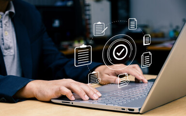Businessman using laptop with document icon and correct mark for standard quality control...