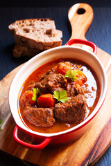 Food concept Homemade Beef stew Goulash on black background with copy space