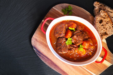Food concept Homemade Beef stew Goulash on black background with copy space