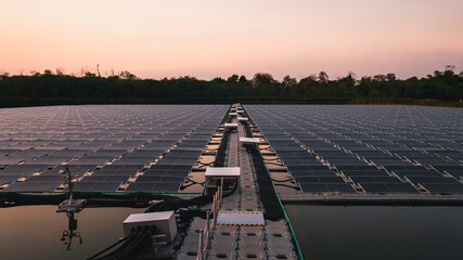 Solar power plant farm on beautifull lake. Floating solar panels providing green energy. Renewable energy.at sunset time.