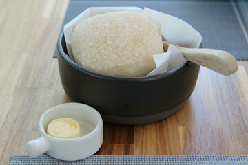 A homemade fresh bread and butter on wooden table