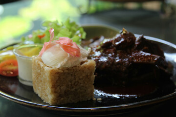 Riceberry with barbecue pork steak and vegetable in ceramic plate