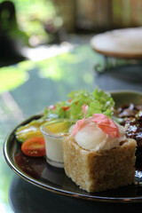 Riceberry with barbecue pork steak and vegetable in ceramic plate
