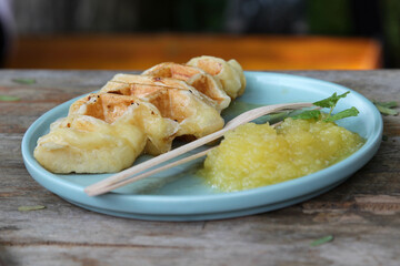 Waffle and pineapple jam on blue plate