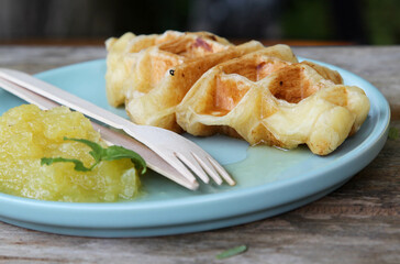 Waffle and pineapple jam on blue plate