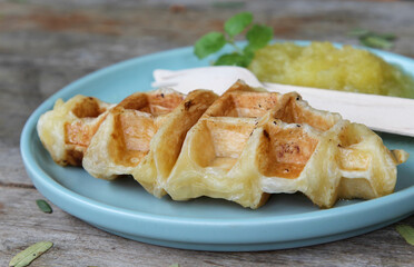 Waffle and pineapple jam on blue plate