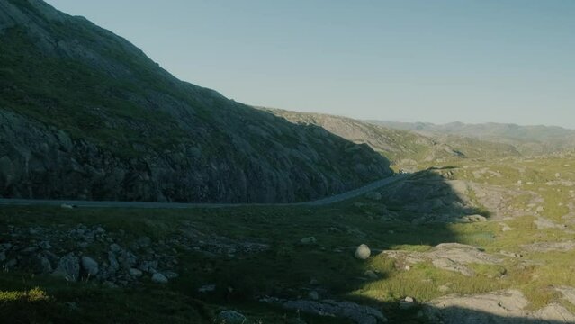 Group of motocycle bikers rides slowly on the asphalt road. Scenic landscape, travel and freedom concept. Near Lysebotn, Norway