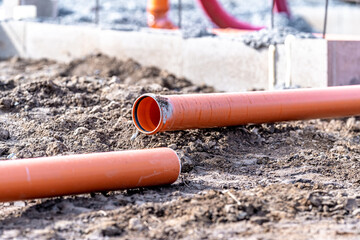 orange PVC plastic pipes on the construction site