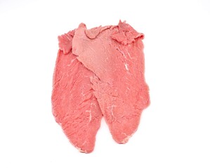 Uncooked selected thinly sliced beef on white background.