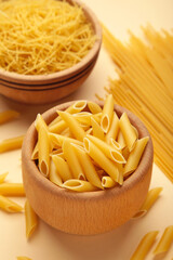 Various types of Italian pasta on beige background