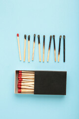 Burnt matches on blue. Different stages of match burning Burnt matches. Full depth of field. Vertical photo