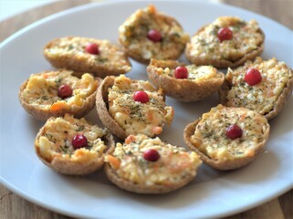 Cheese salad in baskets with garlic and eggs. Delicious snack on a plate. Tartlets with salad. Stuffed baskets with cheese salad