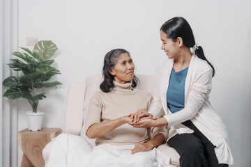 Obraz premium Elderly mother with young daughter asia people only woman sitting on sofa at home have fun enjoying weekend together.