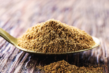 spoon of powdered cinnamon, spice obtained from the inner bark of several species of trees of the...