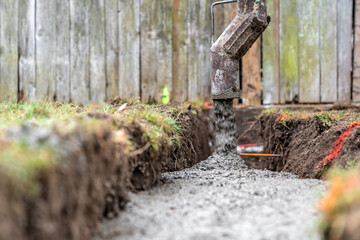 cementing the foundation in the ground when building a house