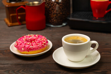 Fragrant delicious espresso coffee with pink strawberry donut, coffee machine on brown texture table. Good morning concept. Morning coffee. Sweet table. Colorful berry buns.Top view.
