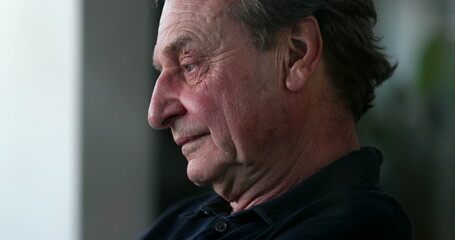 Tired older man yawning and rubbing face with hands. Pensive senior person feeling exhausted